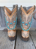 Silver flower concho and turquoise beaded boot bracelet chain with two-strand drape worn on tan tooled laser-cut cowboy boots, full pair front view
