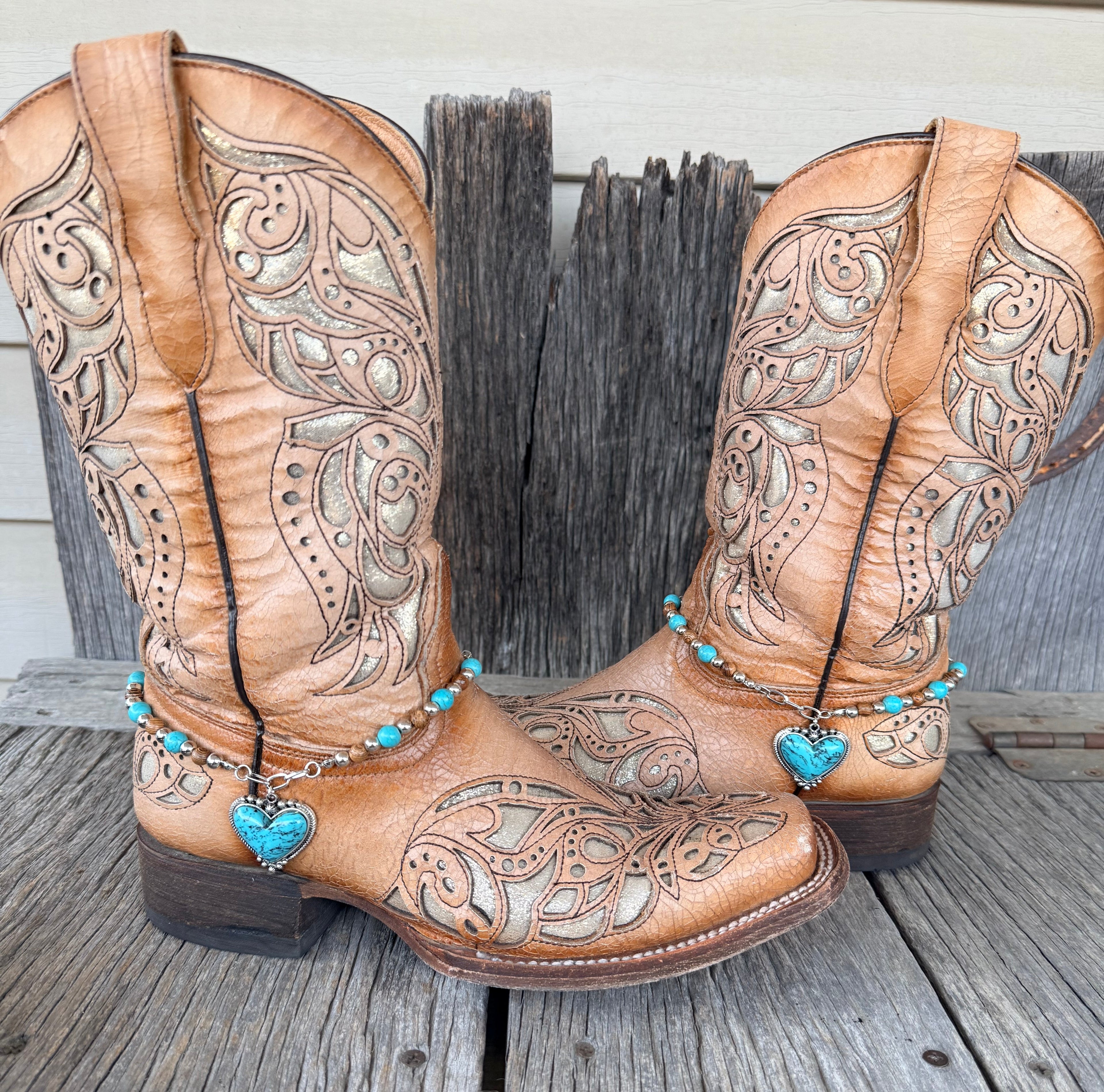 Turquoise heart boot bracelet with turquoise, brown wood and silver beads worn on tan tooled leather cowboy boots, full pair view
