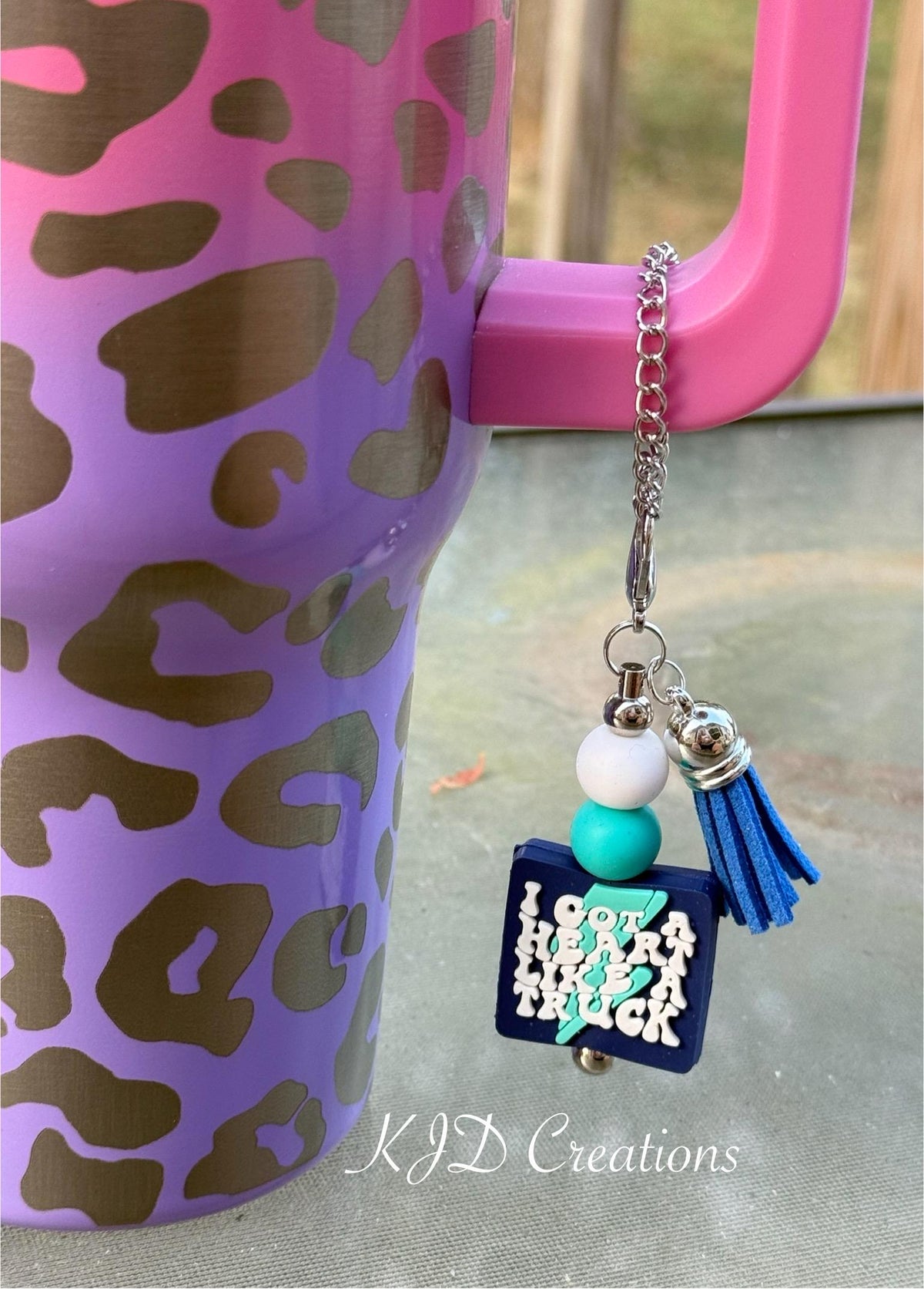 Truck country music tumbler charm clipped to a pink leopard print insulated cup handle — white and teal silicone beads with blue tassel