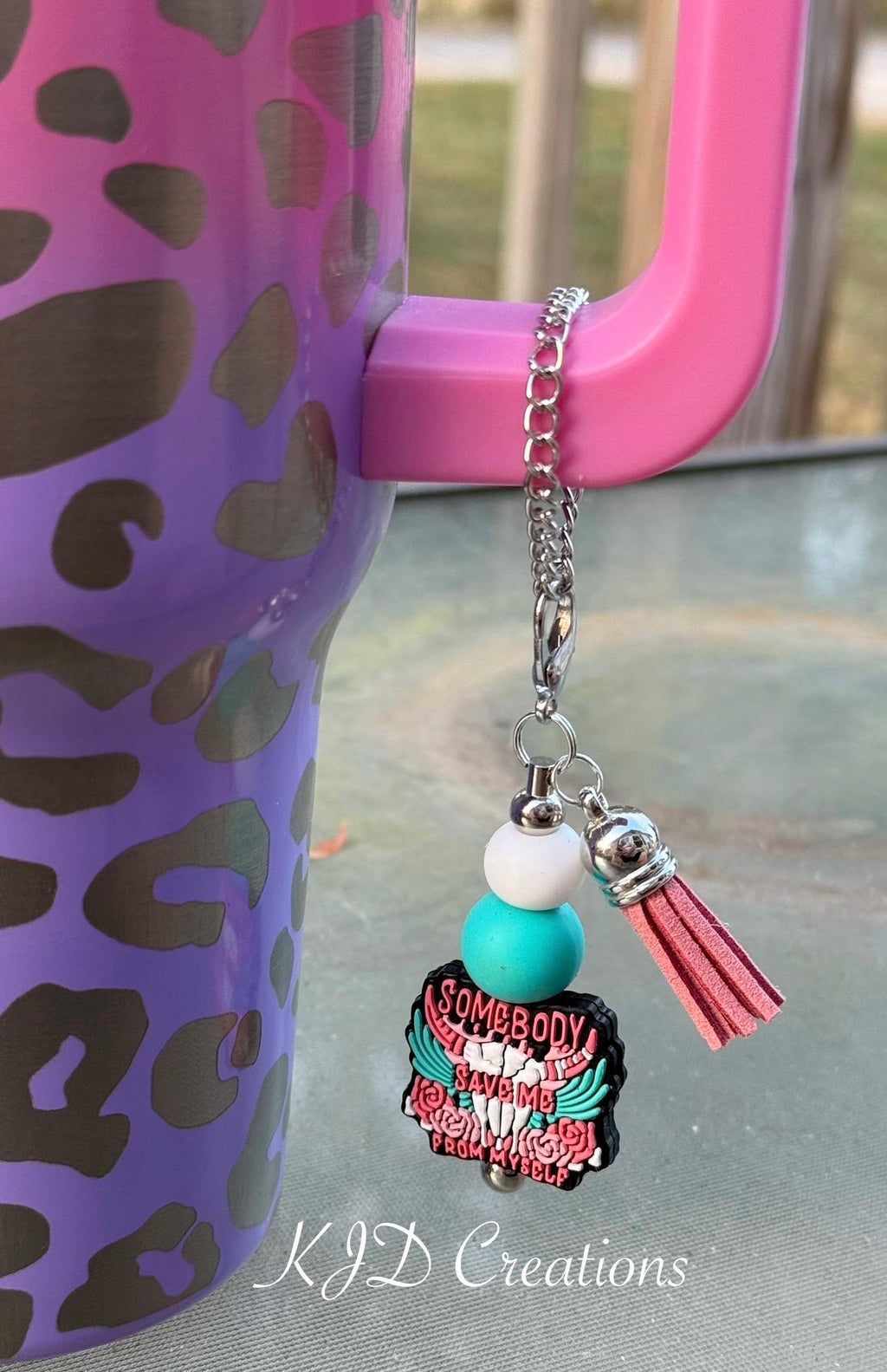 Save Me country music tumbler charm clipped to a pink leopard print insulated cup handle — white and teal silicone beads with pink tassel