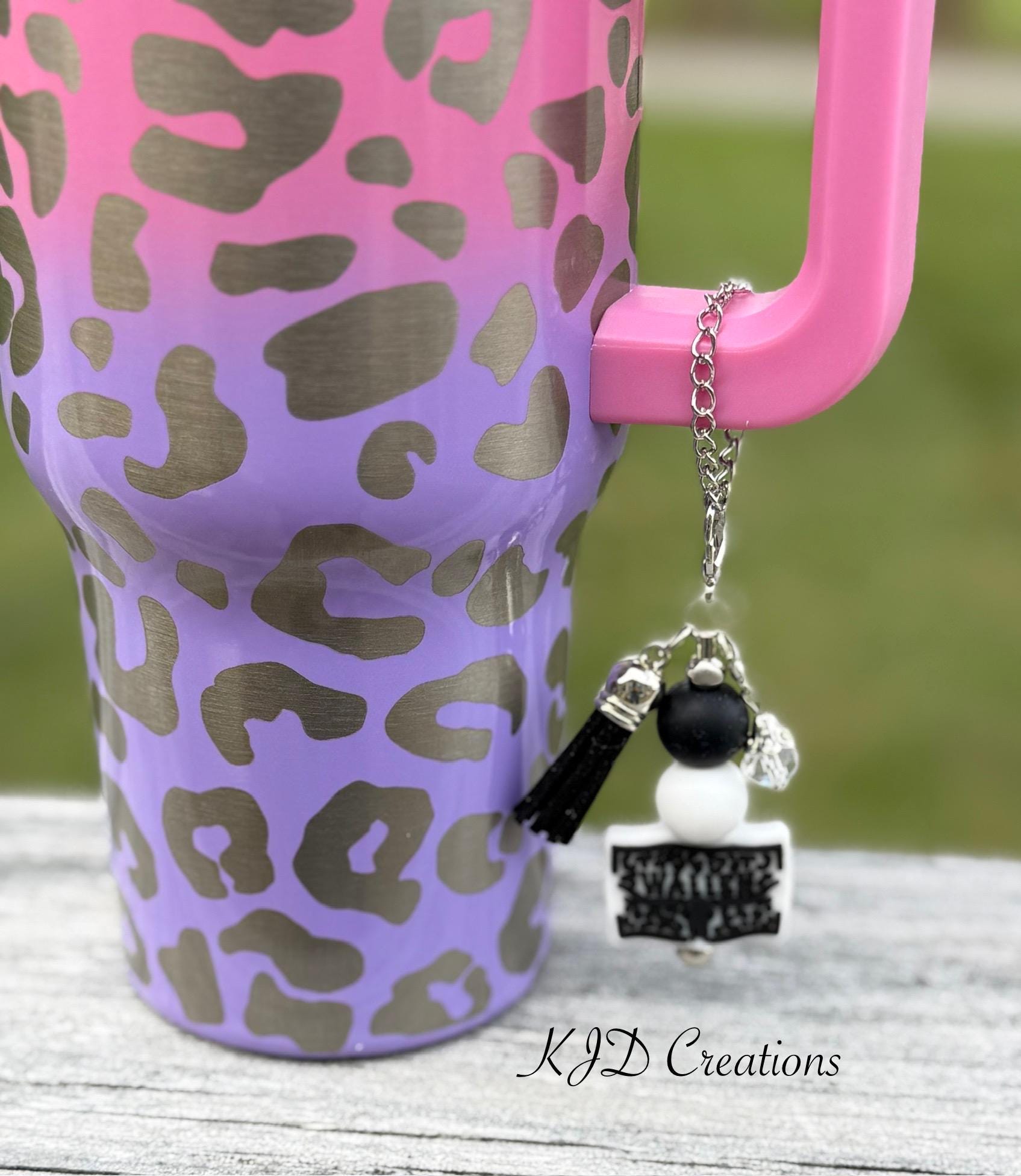 Country Singer country music tumbler cup handle charm clipped to a pink and purple leopard print insulated tumbler — black and white beads with black tassel
