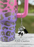 Cowgirl Horse Western tumbler cup handle charm clipped to a pink and purple leopard print insulated tumbler — black and white heart with cowgirl silhouette, cow print bead, and black tassel by KJD Creations