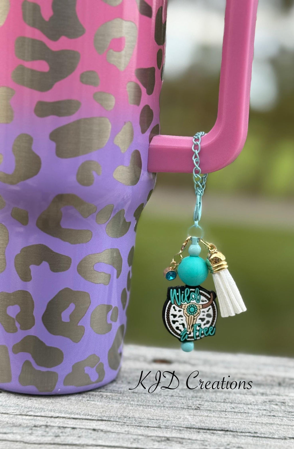 Longhorn Wild & Free Western tumbler cup handle charm close-up — teal longhorn steer charm with turquoise bead and white tassel clipped to insulated tumbler by KJD Creation