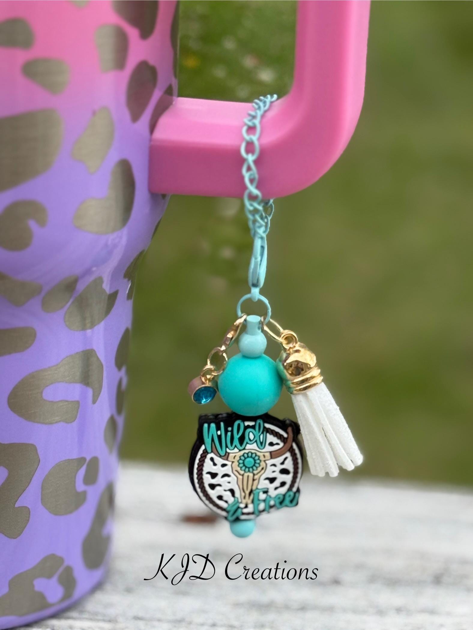Longhorn Wild & Free Western tumbler cup handle charm close-up — teal longhorn steer charm with turquoise bead and white tassel clipped to insulated tumbler by KJD Creation