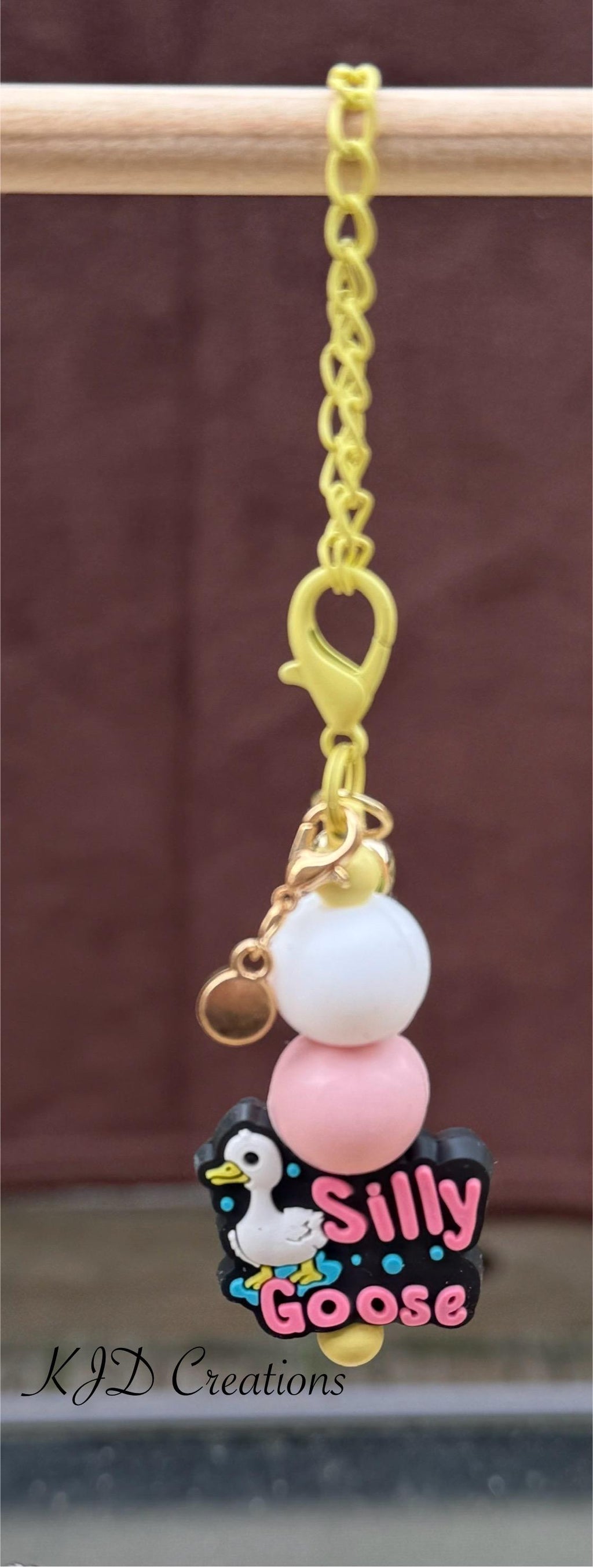 Silly Goose tumbler charm close-up on display rack — gold chain with white and pink silicone beads and Silly Goose tumbler charm by KJD Creations