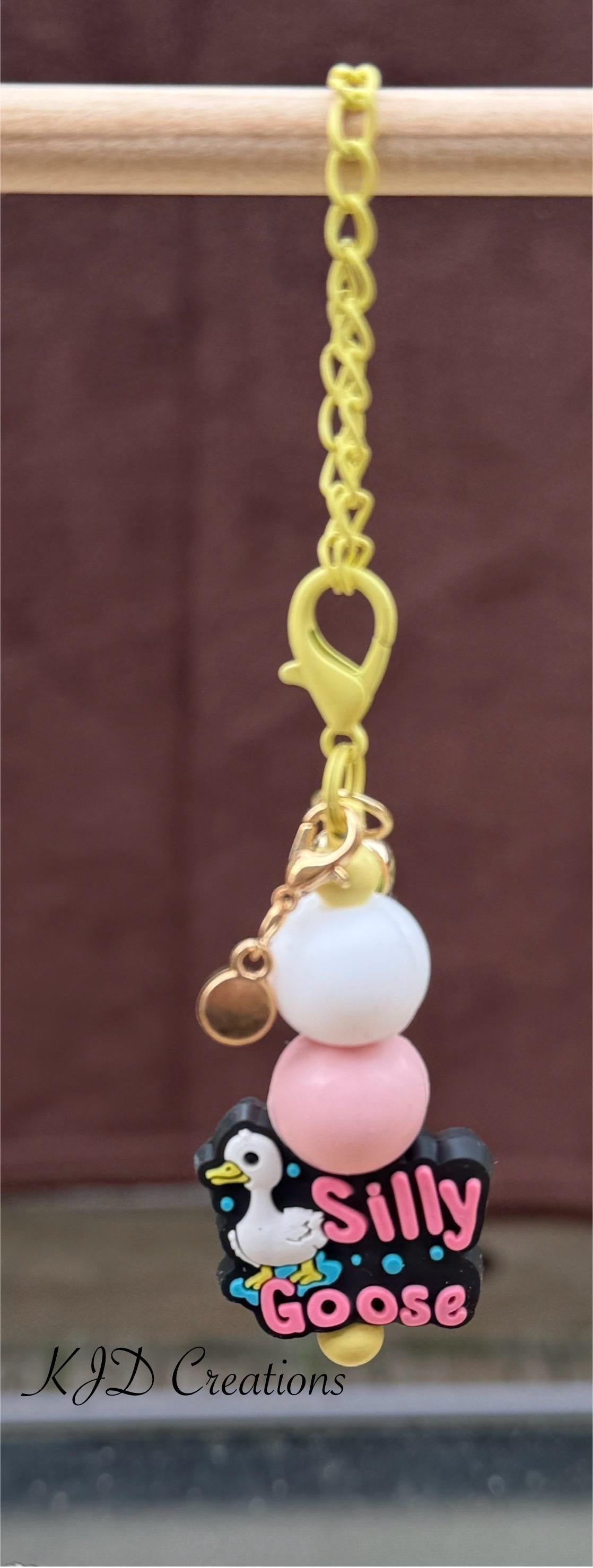 Silly Goose tumbler charm close-up on display rack — gold chain with white and pink silicone beads and Silly Goose tumbler charm by KJD Creations