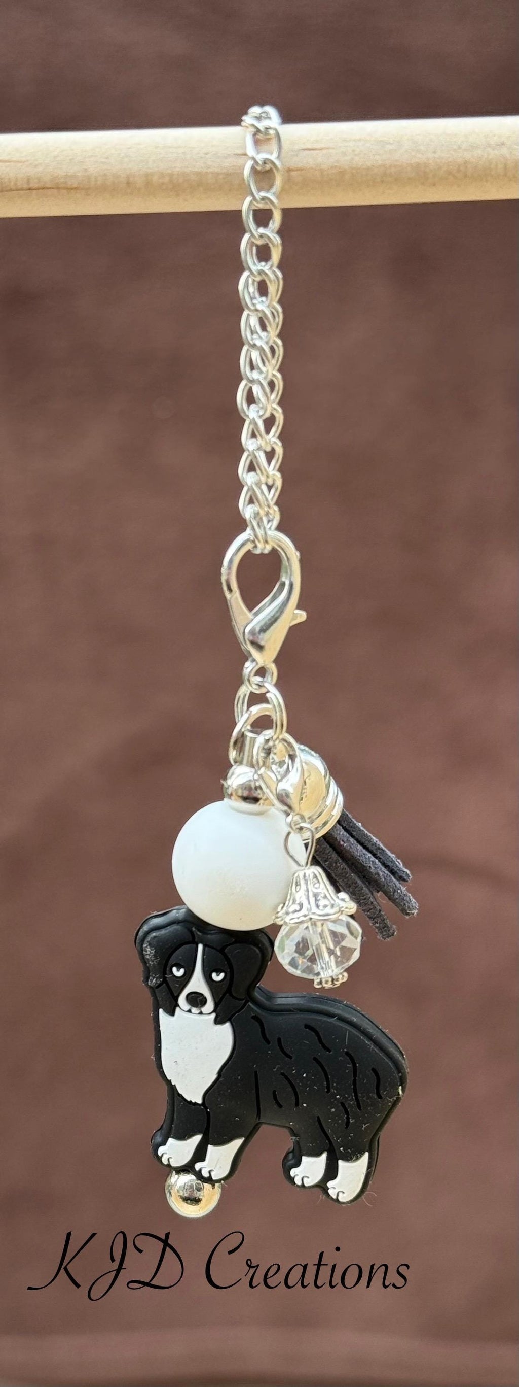 Aussie - Australian Shepherd Dog tumbler cup handle charm on a display rack — silver chain with white bead, black tassel, and Aussie Dog charm by KJD Creations