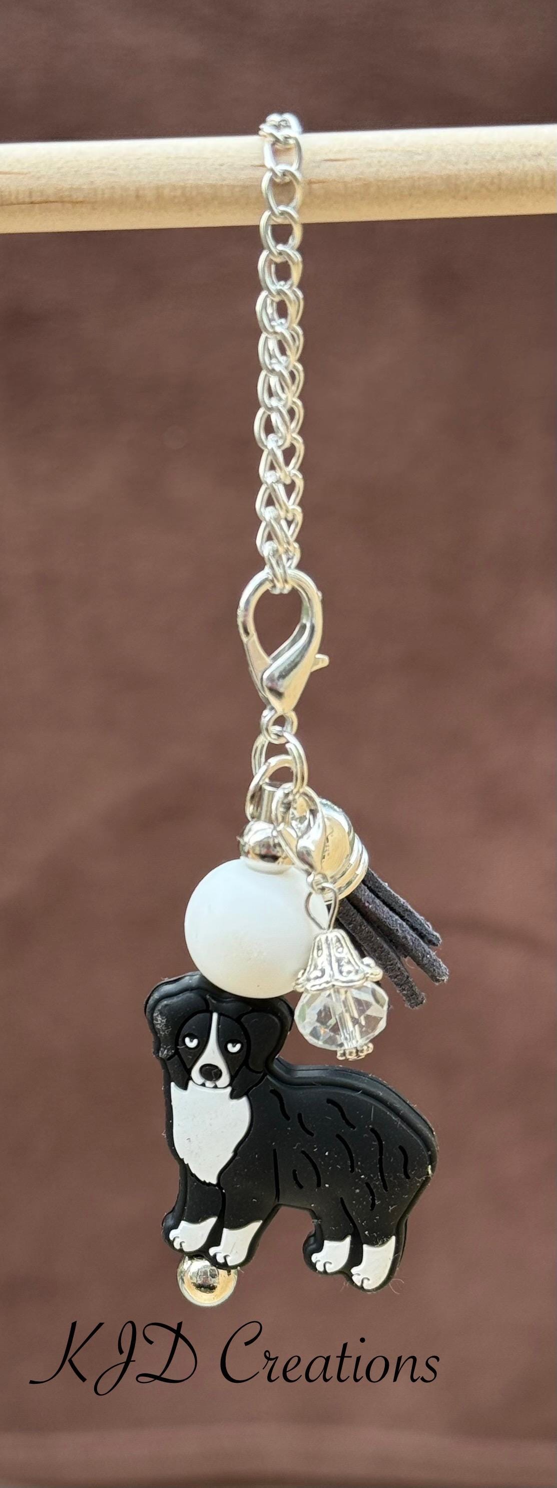 Aussie - Australian Shepherd Dog tumbler cup handle charm on a display rack — silver chain with white bead, black tassel, and Aussie Dog charm by KJD Creations