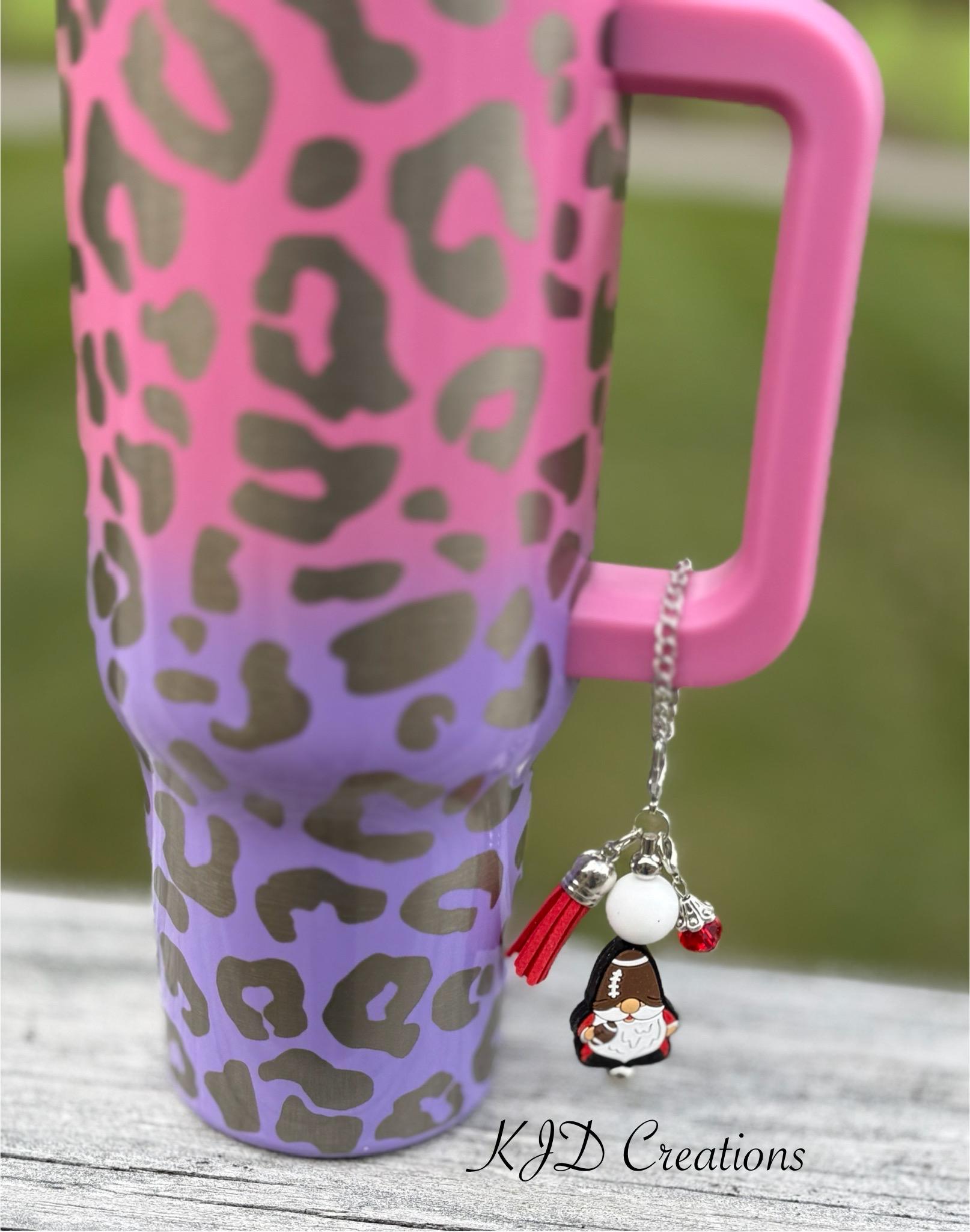 Football Gnome tumbler cup handle charm clipped to a pink and purple leopard print ombre insulated tumbler — silver chain with white bead, red tassel, and football gnome charm by KJD Creations