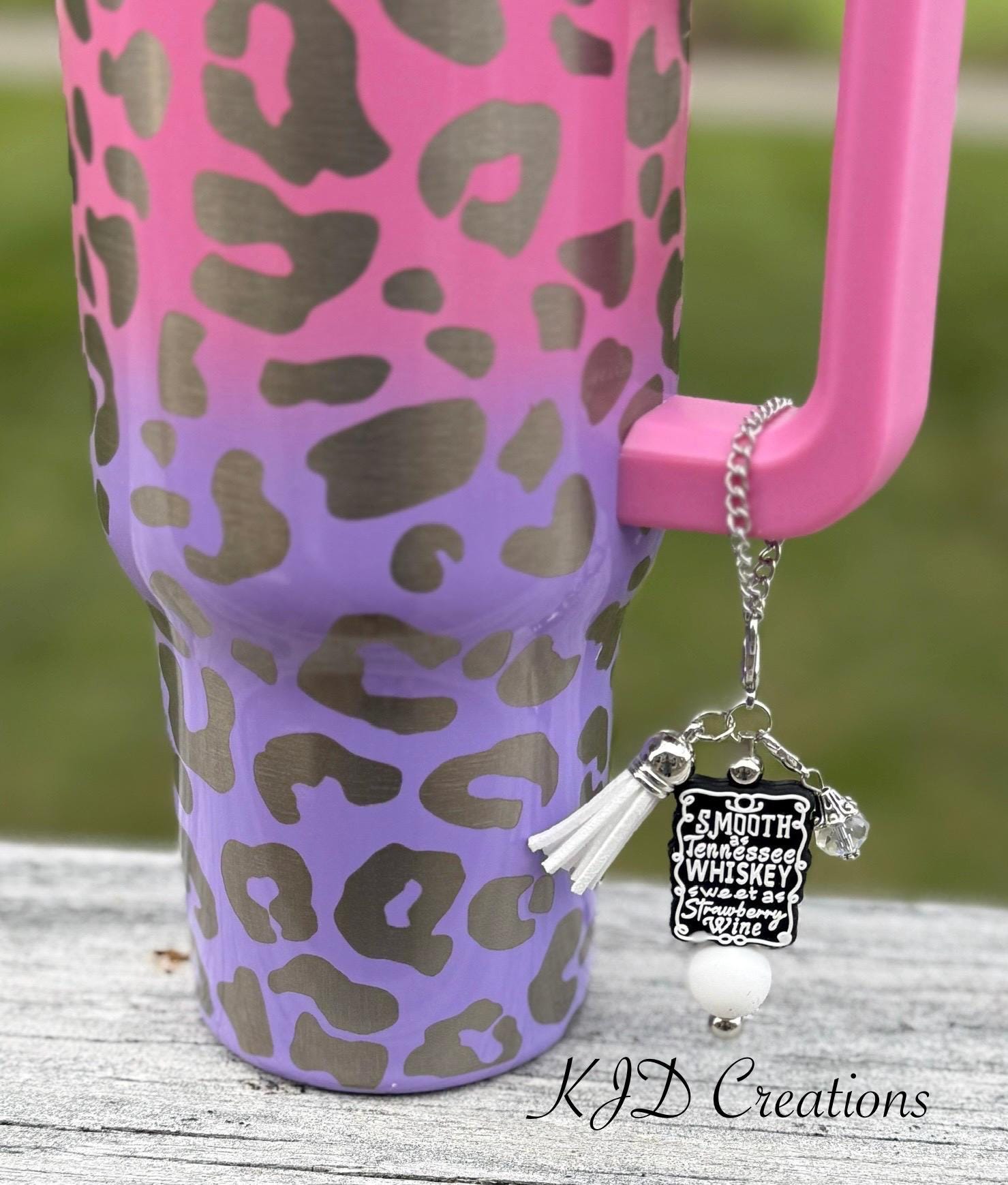 Whiskey & Strawberry country music tumbler cup handle charm clipped to a pink and purple leopard print insulated tumbler — Black & white beads, white leather tassel
