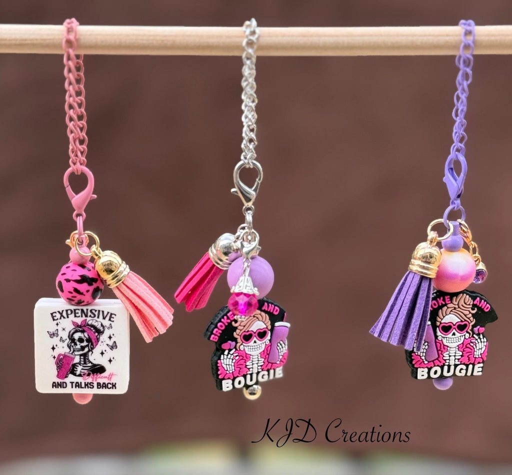 Expensive & Difficult - Broke and Bougie silicone beaded tumbler cup charm with sassy skull pendant, pink silicone bead, and hot pink leather tassel on display rack