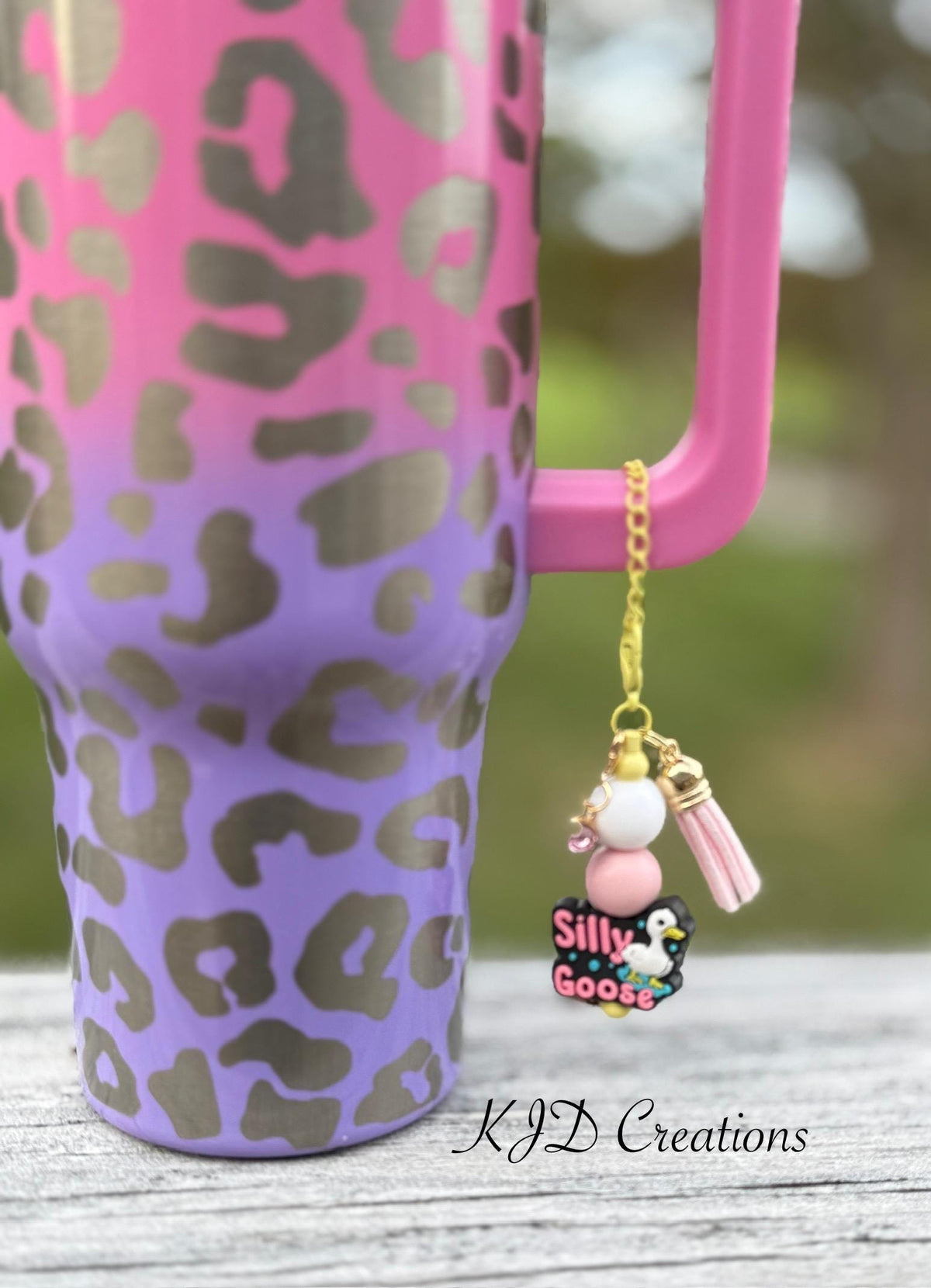 Silly Goose funny tumbler cup handle charm clipped to a pink and purple leopard print insulated tumbler — gold chain with white and pink beads, pink tassel, and Silly Goose penguin charm by KJD Creations
