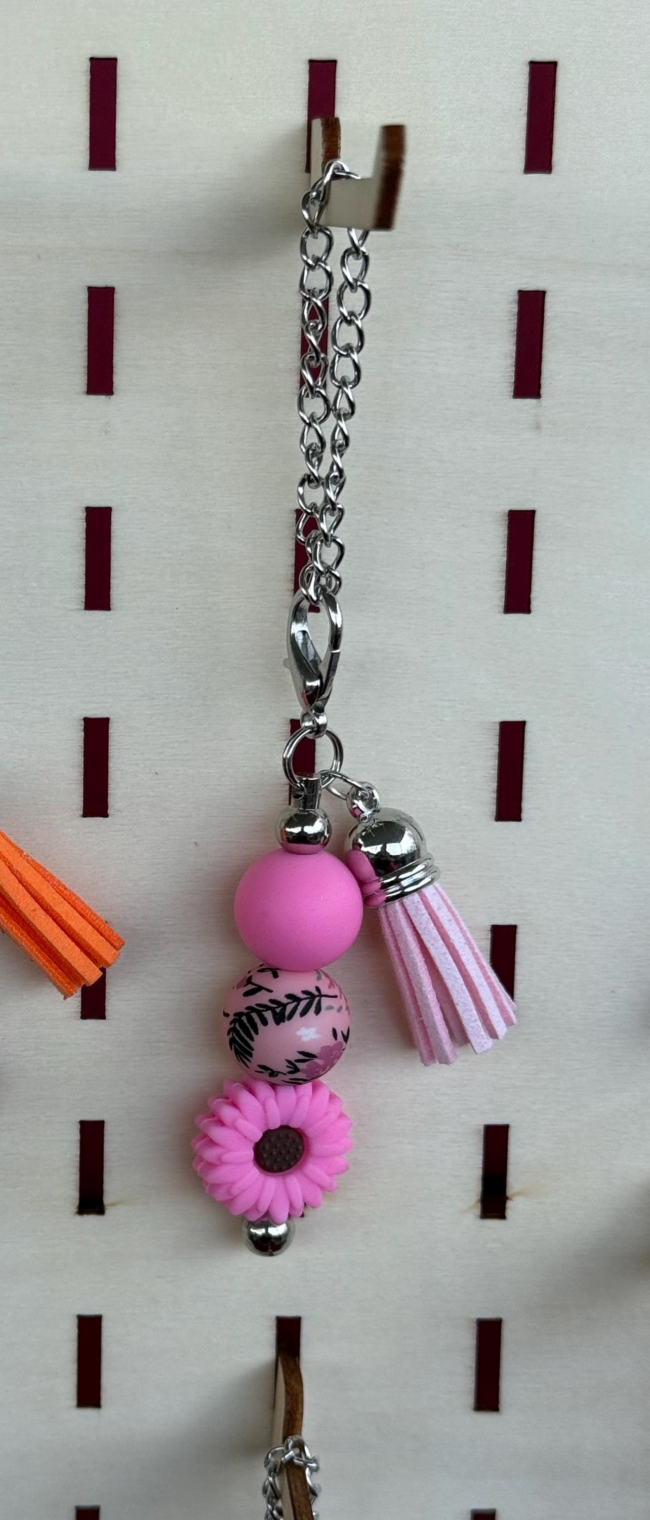 Pink western boho beaded tumbler cup charm with floral bead, pink daisy, and lavender tassel on silver chain