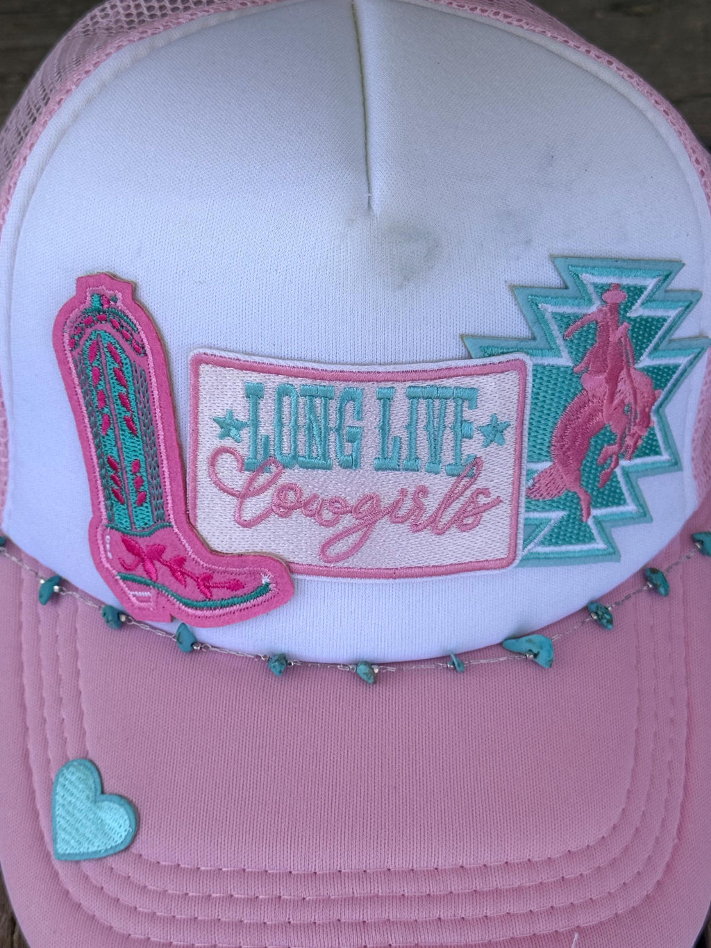 Pink and white trucker hat featuring western-themed embroidery including a cowboy boot, a western figure, and a central patch that reads 'LONG LIVE Cowgirls'.