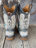 Front view of pair of dark gray distressed cross-embroidered lace-overlay cowboy boots on weathered wood planks wearing three-strand silver chain lei boot bracelets with turquoise oval bead accents and silver cactus charm with turquoise stone, Western boho boot jewelry set of 2