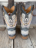 Back view of pair of grey cross embroidered cowboy boots wearing gold link chain and iridescent pink crystal bead boot bracelets with gold butterfly charm, set of 2