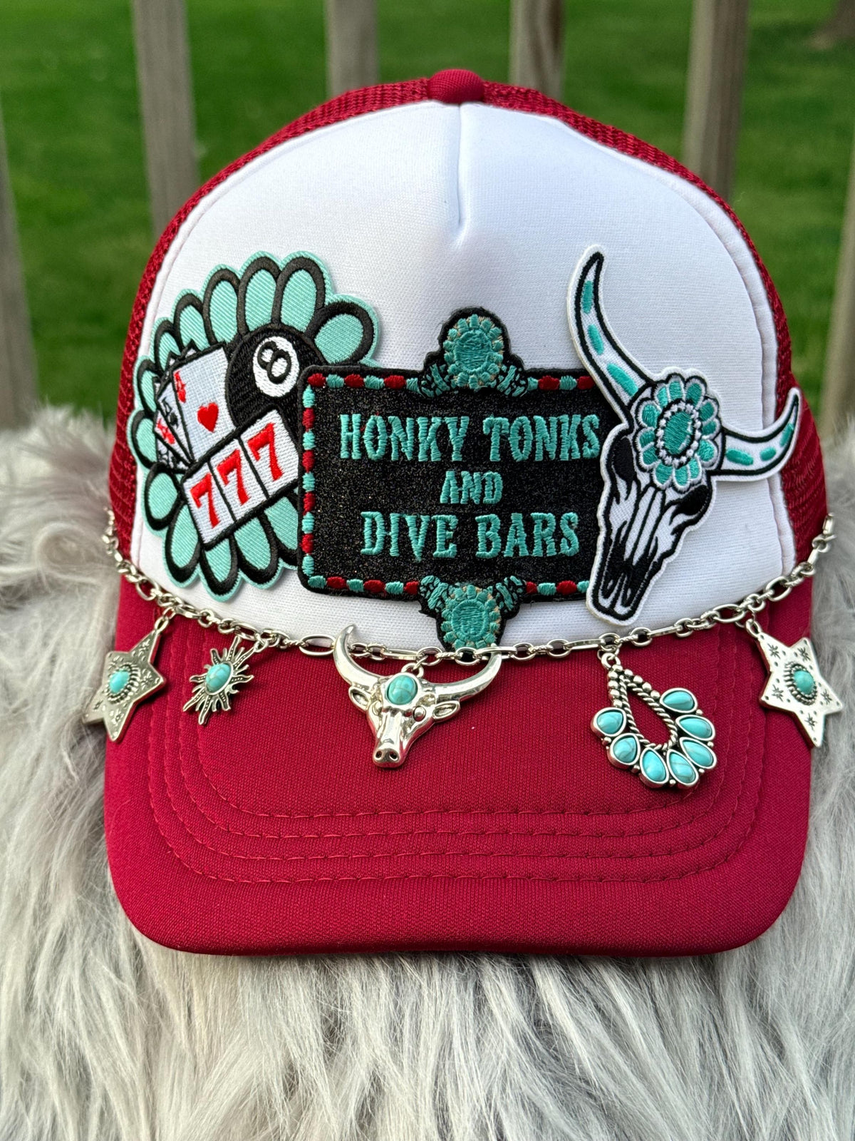 A red and white trucker hat with a custom embroidered patch reading 'HONKY TONKS ' and turquoise accents, 