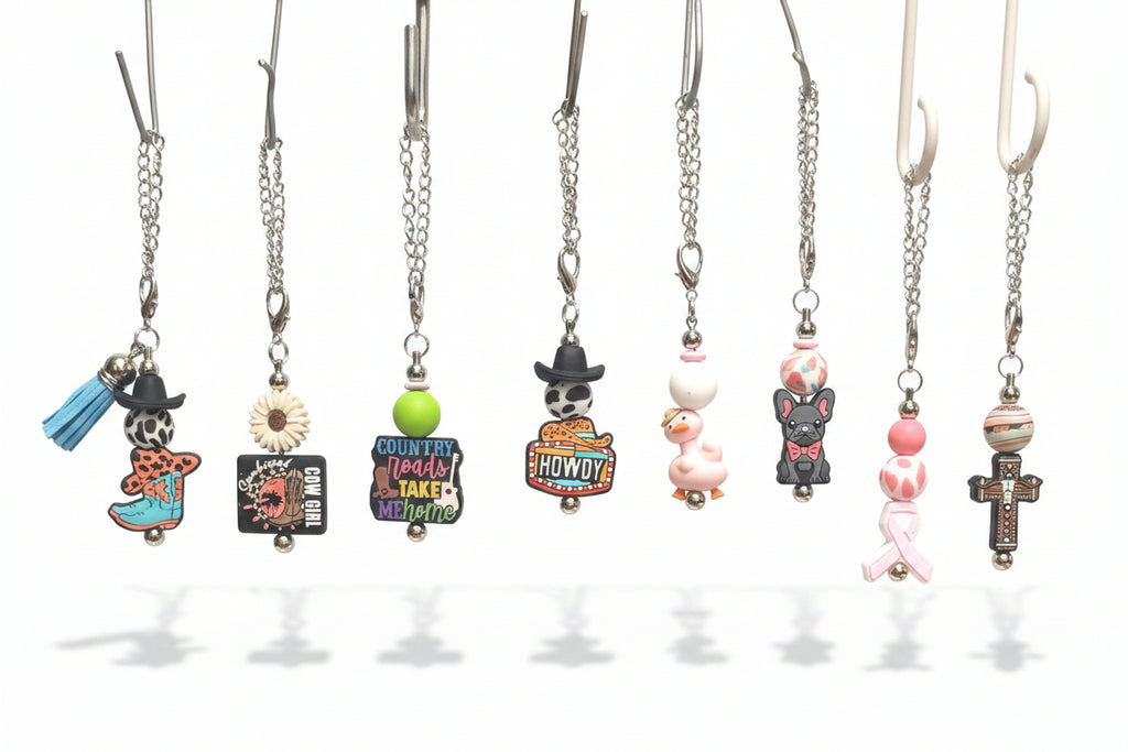 A row of colorful Tumbler charms. Cowboy Boots, Sunkissed Cowgirl, Country Roads, Howdy, Pink Goose, French Bulldog, Breast Cancer Ribbon, Western Cross