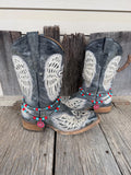 Pair of black embroidered cowboy boots styled with faux Navajo pearl, turquoise, and red beaded boot bracelets with red flower charms
