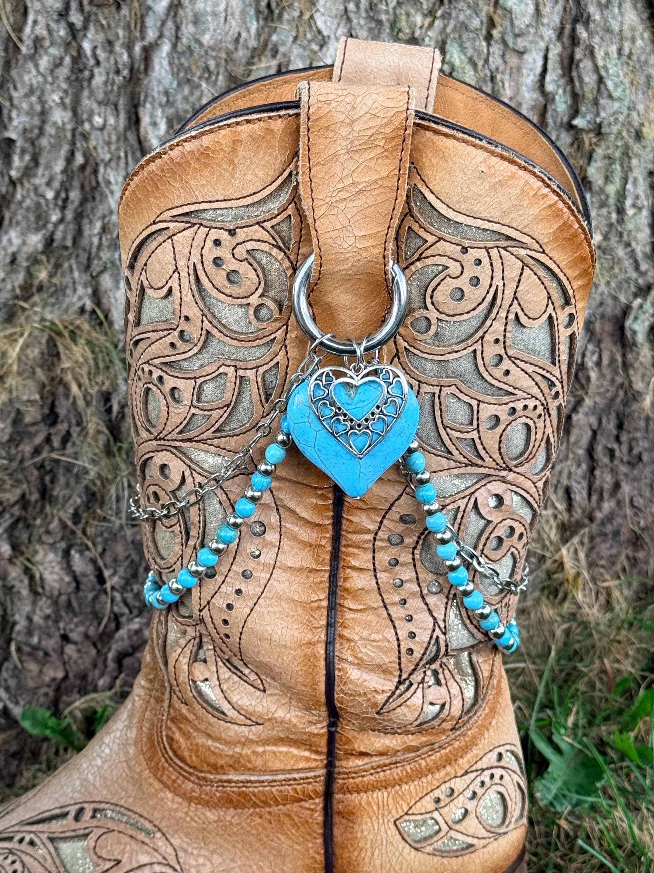 Front view of tan tooled laser-cut cowboy boot with two-strand lei boot bracelet and large turquoise stone heart with silver filigree overlay pendant, Western boho boot jewelry