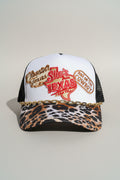 A white trucker hat with black mesh back panels, a leopard-print visor, and a gold chain across the front. The front features embroidered Texas', 