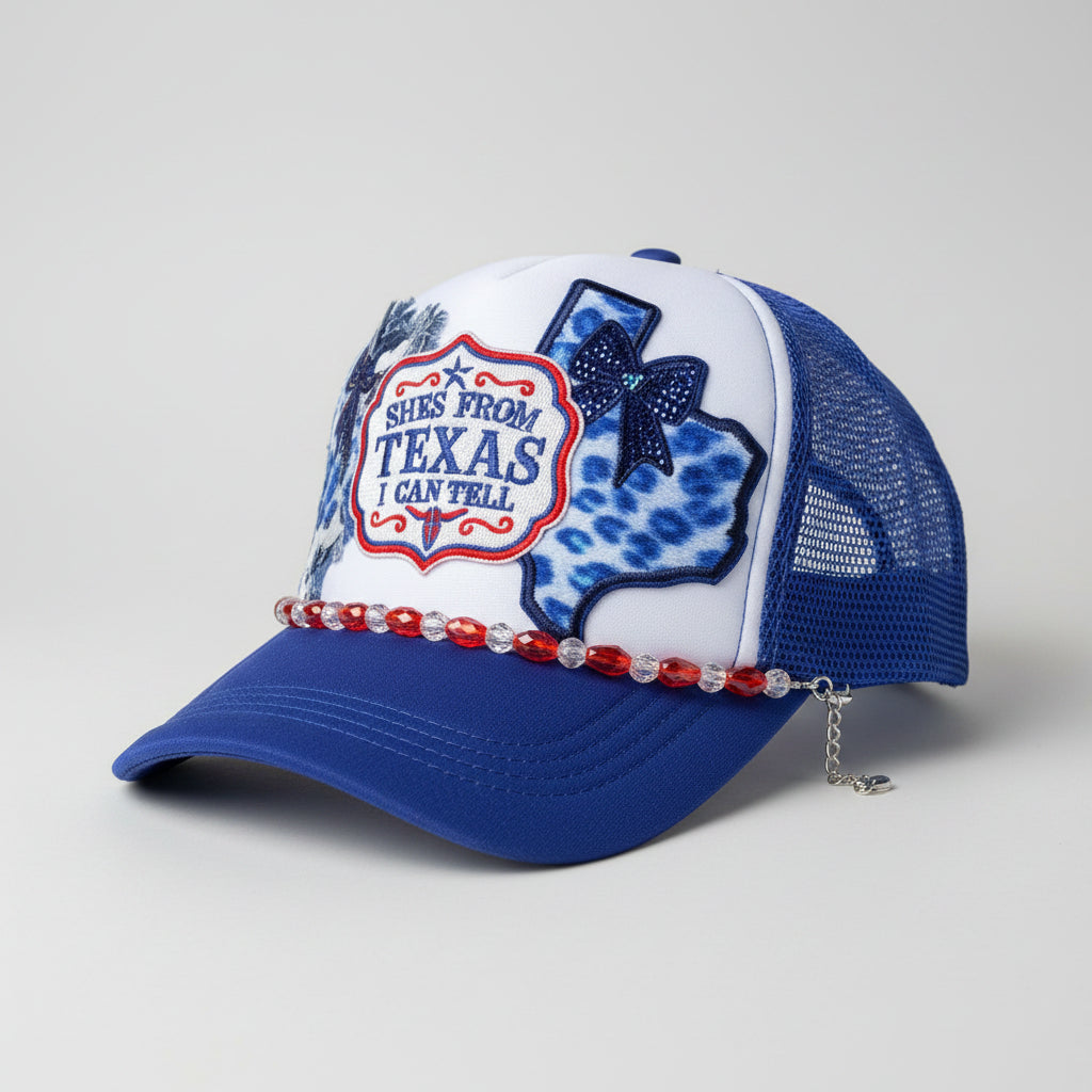 A blue and white trucker hat with a Texas-themed patch on the front, 